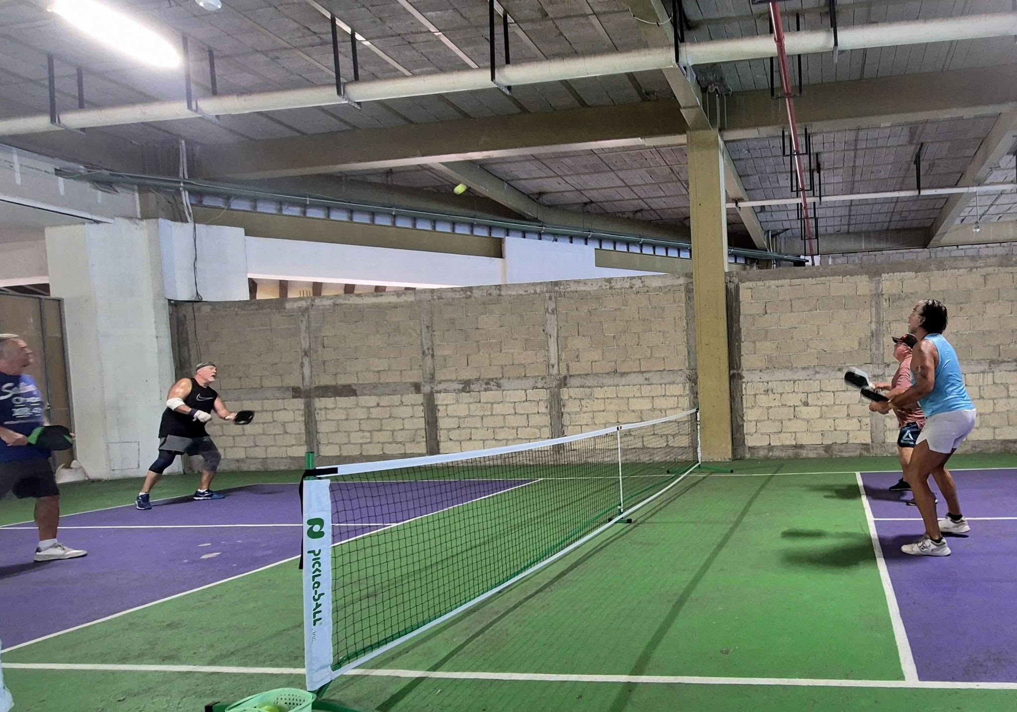 Full court view with players at the net