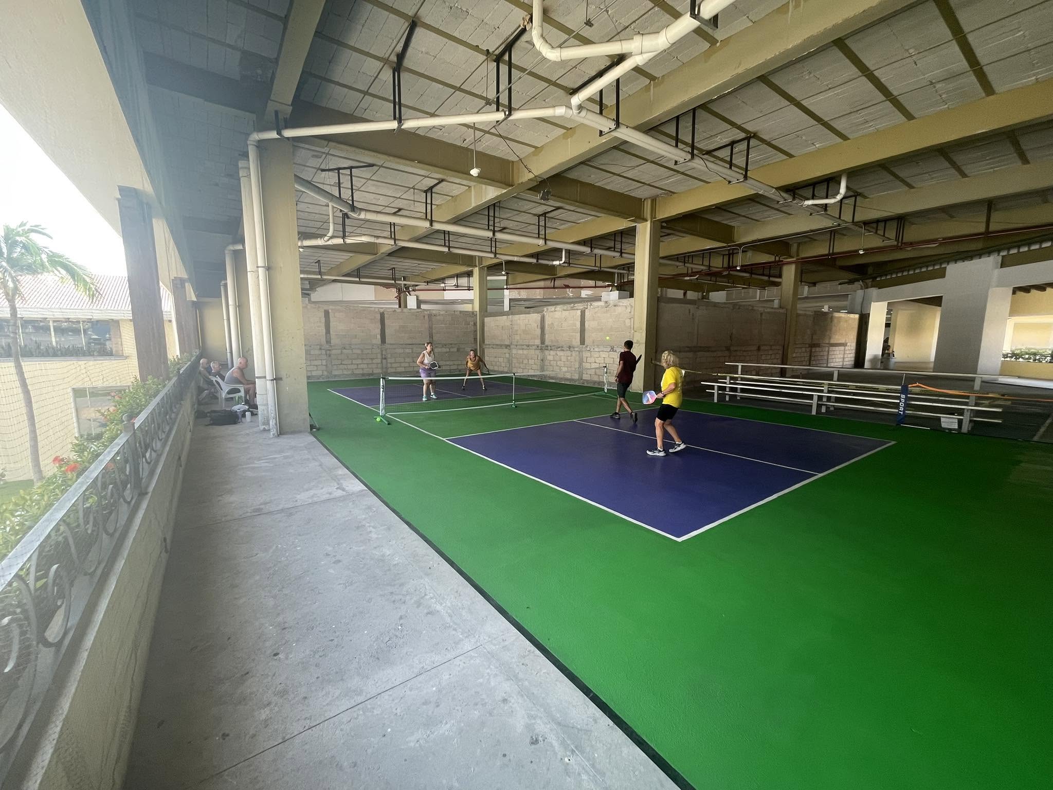 Multiple indoor courts showing the scale of the facility