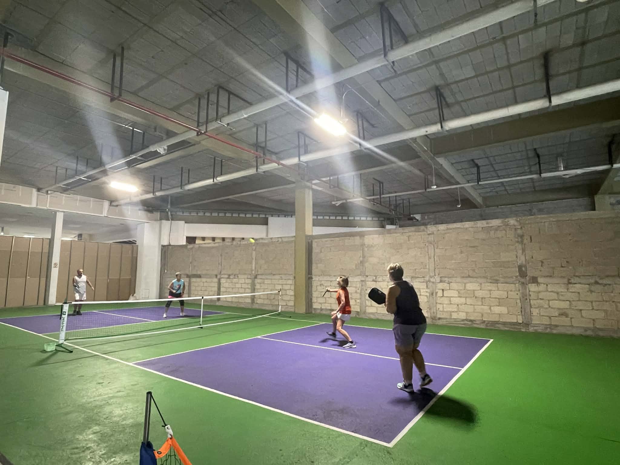 Wide view of the indoor pickleball courts at Puerto Mágico